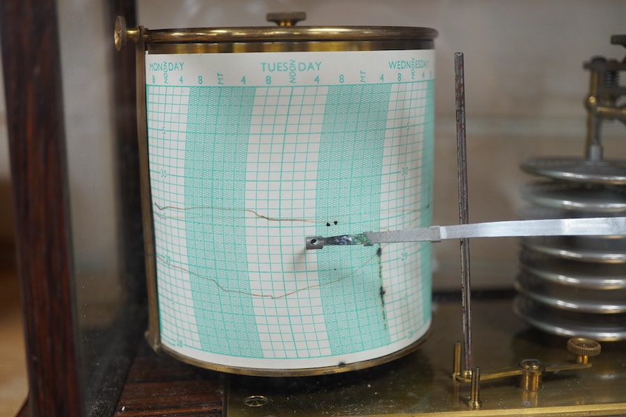 An early 20th century oak cased barograph, without maker’s mark, however stamped 418 into the case and with an unusual hinged lid, ivory backed thermometer and integral drawer beneath containing two boxed Negretti & Zamb
